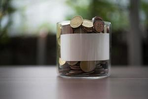 geld besparen voor investeringsconcept munt in de glazen pot foto