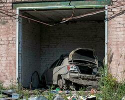 beschadigd en geplunderd auto's in een stad in Oekraïne gedurende de oorlog foto