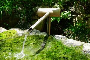 een Japans bamboe water fontein shishi-odoshi in zen tuin foto