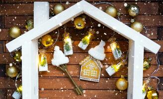 sleutel naar huis met een sleutelhanger klein huis Aan houten achtergrond met Kerstmis decor indeling. geschenk voor nieuw jaar, kerstmis. gebouw, projecteren, in beweging naar nieuw huis, hypotheek, huur en aankoop echt landgoed foto