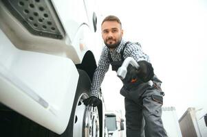 beschadigd band. jong vrachtauto bestuurder is met zijn voertuig Bij dag foto