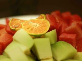 een verrukkelijk verscheidenheid van vers meloen, watermeloen en papaja plakjes voor een verleidelijk vers genot foto