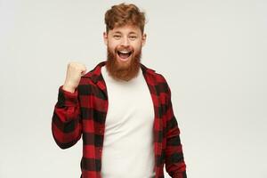 een Mens met een baard en rood plaid overhemd is glimlachen foto