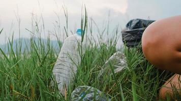 gelukkige jonge azië-activisten die plastic afval in het bos verzamelen. Koreaanse vrouwelijke vrijwilligers helpen de natuur schoon te houden en vuilnis op te halen. concept over milieubehoud vervuilingsproblemen.