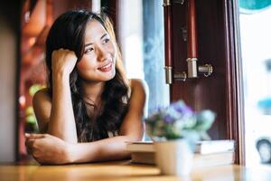 portret aziatische vrouw die lacht ontspannen in coffeeshop cafe foto