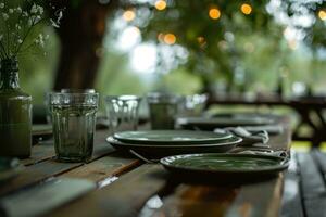 ai gegenereerd een groen tafel met platen, bril en een boom in de achtergrond foto