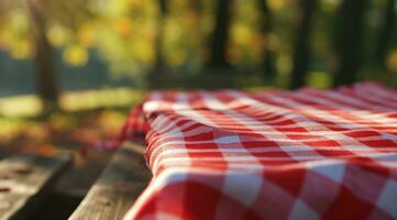 ai gegenereerd rood kleding picknick tafelkleed Aan de picknick tafel in herfst natuur achtergrond foto
