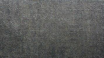 detailopname van getextureerde donker grijs kleding stof, getextureerde achtergrond foto