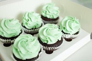 banketbakker siert cupcakes, eigengemaakt Koken, snoepgoed. groen room foto