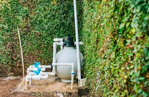 huis zwemmen zwembad filter en behandeling fabriek geïnstalleerd. zwembad pomp met zand filter geïnstalleerd. zwembad Zuivering en onderhoud systeem foto