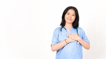 jong Aziatisch vrouw dokter hand- Aan borst dankbaar gebaar geïsoleerd Aan wit achtergrond foto