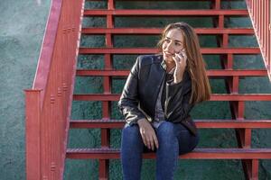 glimlachen vrouw sprekend via smartphone Aan trap foto