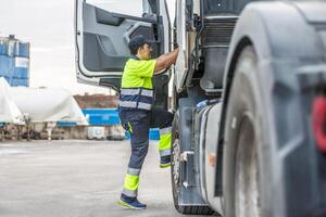 mannetje bestuurder beklimming stappen in vrachtauto terwijl voorbereidingen treffen voor reis foto