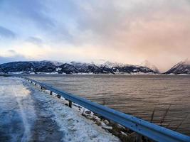 rijden bij zonsopgang door de fjord op ijzel, noorwegen. foto