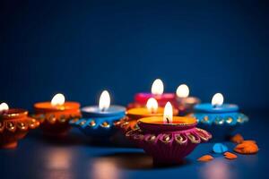 ai gegenereerd gelukkig diwali - klei diya lampen lit Aan blauw achtergrond gedurende diwali viering, neurale netwerk gegenereerd fotorealistisch beeld foto