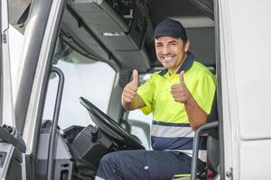 glimlachen bestuurder in veiligheid kleding tonen dubbele goedkeuring met duimen omhoog foto