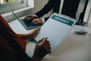 detailopname Aziatisch mannetje mensen auto verkoper of verkoop manager aanbiedingen naar verkopen een auto en legt uit en leest de voorwaarden van ondertekening een auto contract en verzekering. foto