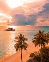 antenne zonsopkomst zonsondergang strand baai visie, kleurrijk lucht en wolken, houten steiger over- water bungalow. meditatie ontspanning tropisch dar visie, zee oceaan water. antenne natuur hemellandschap zeegezicht achtergrond foto