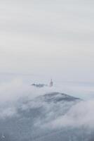 hoogste top van beskydy bergen lysa hora onder de ochtend- mist en wit sneeuw omslag. winter maanden Aan planeet aarde foto