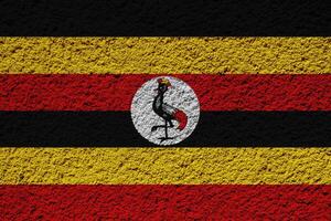 vlag van republiek van Oeganda Aan een getextureerde achtergrond. concept collage. foto