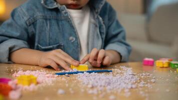 dichtbij omhoog hand. Aziatisch schattig weinig meisje aan het leren en spelen naar gebruik kleurrijk Speel deeg in de leven kamer Bij de huis. baby werkzaamheid onderwijs ontwikkeling levensstijl concept. foto