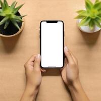 ai gegenereerd hand- Holding een blanco mockup telefoon Aan een top visie foto