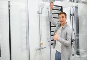 Mens kiezen douche cabine en gereedschap voor zijn huis badkamer foto