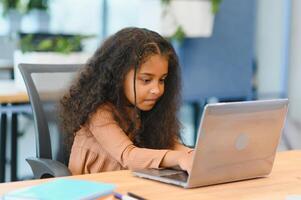 Afrikaanse Amerikaans meisje aan het studeren Bij laptop. online aan het leren foto