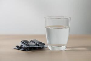 drinken water en geneeskunde voor behandelen ziekten Aan de houten tafel. foto