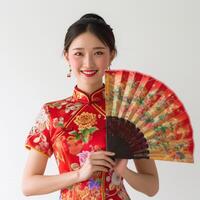 ai gegenereerd mooi Aziatisch vrouw vervelend Chinese cheongsam en Holding ventilator foto