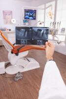 specialist radioloog Holding medisch tanden radiografie in handen onderzoeken tandenverzorging chirurgie expertise. orthodontist dokter werken in stomatologie tandheelkundig orthodontisch ziekenhuis kantoor kamer foto