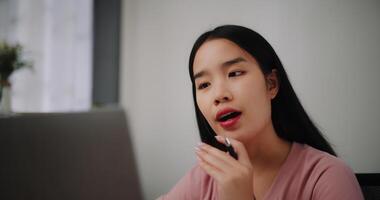 portret van jong vrouw aan het doen video conferentie Aan een laptop Aan een bureau in huis kantoor. foto