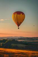 ai gegenereerd een geel en rood heet lucht ballon vliegend over- een veld- foto