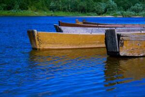traditioneel houten platbodem boten Aan de rivier- bank, landelijk landschap foto