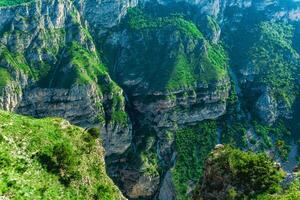 prachtig berg landschap met groen rotsachtig steil hellingen van een reusachtig natuurlijk Ravijn foto