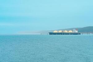 lng vervoerder schip gedurende bezig met laden Bij een vloeibaar gemaakt natuurlijk gas- offshore terminal foto