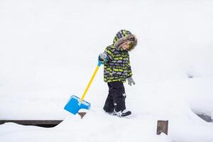 weinig kind wandelen in winter besneeuwd park foto