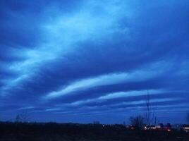 ongelooflijk helder avond blauw lucht met lang wolken uitrekken aan de overkant de lucht foto