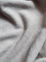 textuur, patroon, achtergrond van vuil wit handdoek blootgesteld naar zonlicht foto