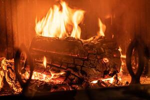 log van hout brandend in een haard binnen een huis, haard foto