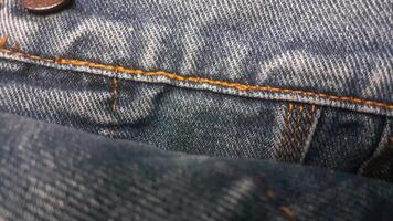 denim blauw jeans structuur met stiksels foto