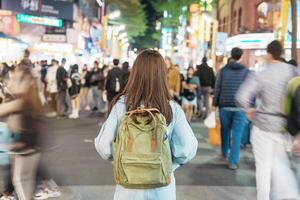 vrouw reiziger bezoekende in Taiwan, toerist met zak bezienswaardigheden bekijken en boodschappen doen in ximending straat markt, mijlpaal en populair attracties in Taipei stad. Azië reizen en vakantie concept foto