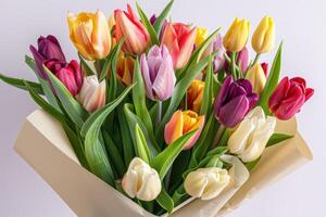 ai gegenereerd boeket van voorjaar tulpen met bloemen van verschillend kleuren verpakt in geschenk papier geïsoleerd Aan wit achtergrond foto