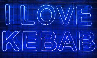 neon schijnend teken in blauw kleur Aan een steen muur met de opschrift of leuze ik liefde kebab. steen muur, achtergrond. helder elektrisch neon licht. café-restaurant doner kebab. foto