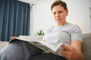 vrouw lezing krant- Bij huis foto