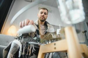 ziek gebaard Mens wie heeft slecht verkoudheid of seizoensgebonden griep zittend Aan bankstel Bij huis. vent met koorts vervelend warm plaid rillingen met bezorgd gezicht uitdrukking. foto