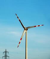 wind boerderij park en hoog Spanning torens De volgende naar een weg in Oostenrijk in zonnig het weer. foto