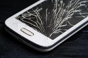 smartphone met gebroken scherm Aan donker achtergrond. detailopname foto