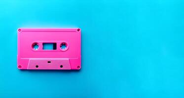 ai gegenereerd retro roze audio cassette Aan blauw achtergrond.stijl 80-90 muziek. foto