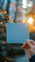 ai gegenereerd hand- Holding blanco blauw papier met een zacht bokeh achtergrond verticaal mobiel behang foto